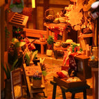 Japanese book nook kit detail – cherry blossom market stalls and warm lantern light